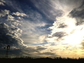 Scenic view of field against sky at sunset