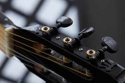 Tuning pegs at top of a guitar, close up