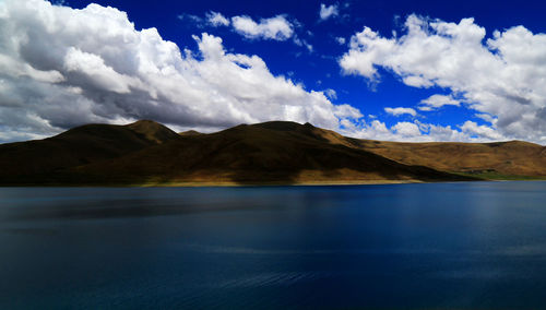 Scenic view of lake and mountains against sky