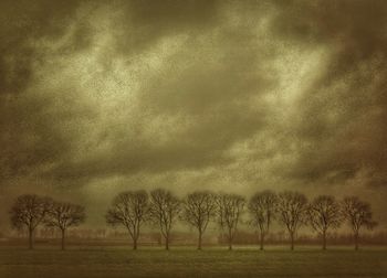 Scenic view of field against cloudy sky