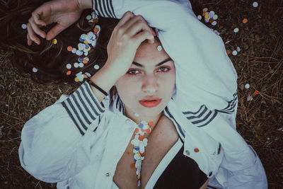 High angle portrait of young woman sitting outdoors