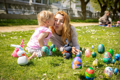 Full length of boy playing with easter egg on field