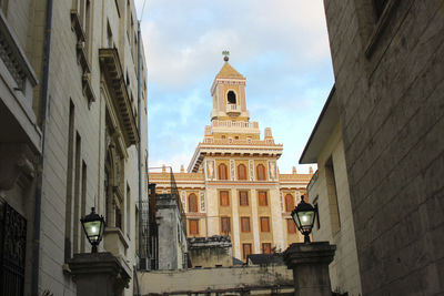 Statue of cathedral against cloudy sky