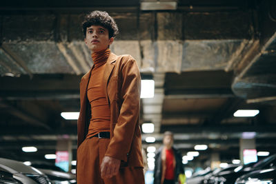 Portrait of young man standing in city