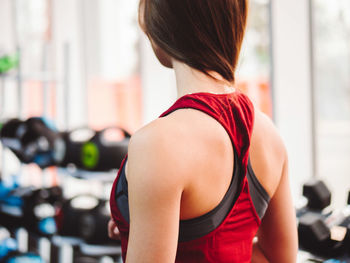 Rear view of woman standing in gym