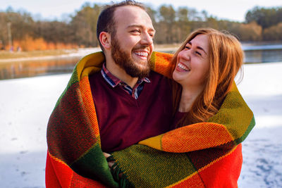 Portrait of young couple hugging in autumn park