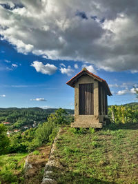 Built structure on field against sky