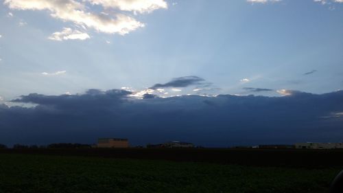 Scenic view of landscape against cloudy sky