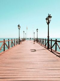 View of pier on sea against clear sky