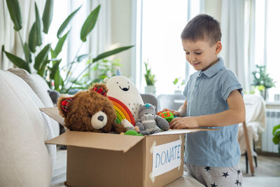 Portrait of boy with teddy bear at home