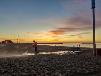 Scenic view of beach against sky during sunset