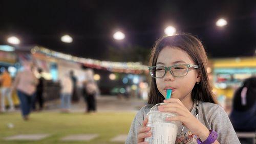 Portrait of young woman drinking glass