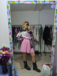 Woman standing on rack in store