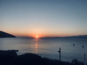 Scenic view of sea against clear sky during sunset