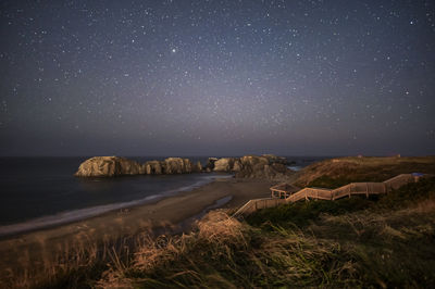 Scenic view of field against sky at night