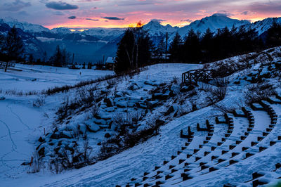 Scenic view of snow covered mountains against sky during sunset