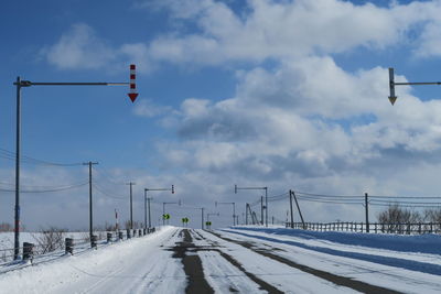 Road by street against sky during winter