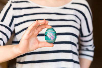 Midsection of woman holding easter egg