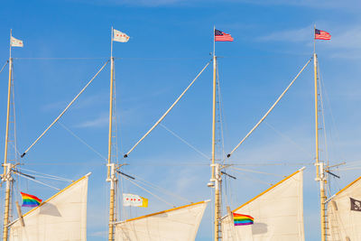 Low angle view of flag against blue sky