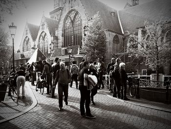 Group of people walking in front of buildings