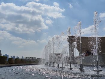 Water splashing fountain against sky