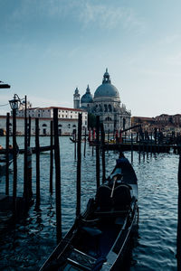 Gondolas moored at port against st mark cathedral