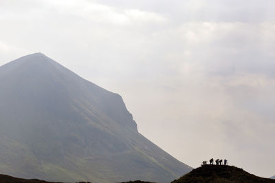 Scenic view of mountains against cloudy sky