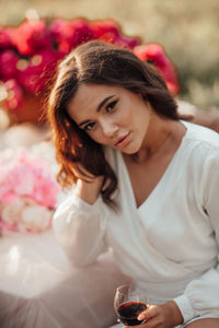 Portrait of beautiful woman sitting on table