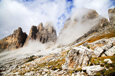 Idyllic view of dolomites against cloudy sky