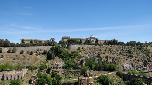 Built structure on landscape against sky