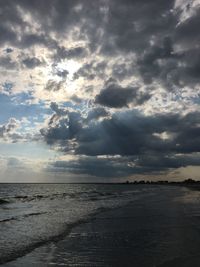 Scenic view of sea against storm clouds