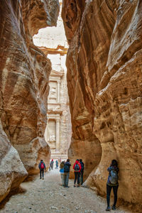 People walking on rock formation