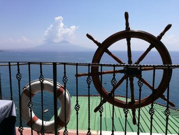 Traditional boat sailing in sea against sky