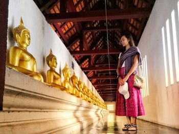 Statue of buddha against building