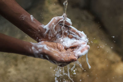 Close-up of hand splashing water