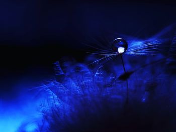 Close-up of illuminated lighting equipment against black background