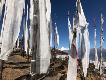 Buddhist flags on mountain against sky