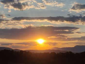 Scenic view of silhouette mountains against sky during sunset