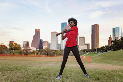 Woman stretching while exercising at park