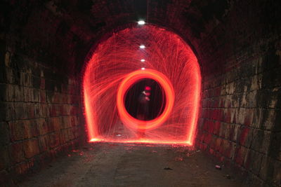 Red wire wool spinning in tunnel at night