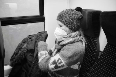 Woman with  mask sitting in train