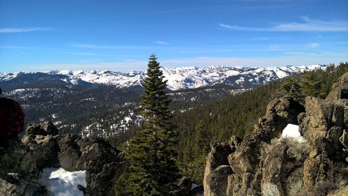 Scenic view of snow covered mountains against cloudy sky