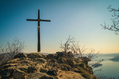 Low angle view of cross against sky during sunset