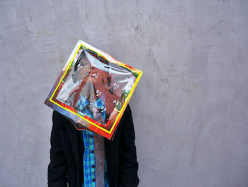 Close-up of gift box on boy's head