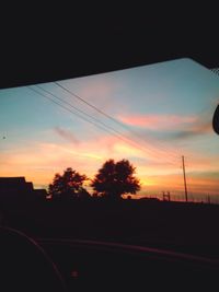 Cars on road at sunset