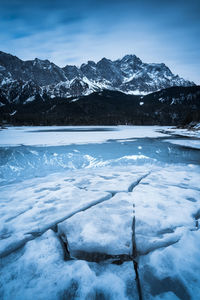 Scenic view of snow covered mountains against sky