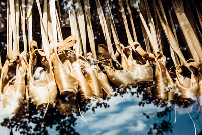 Low angle view of ballet shoes seen through glass window