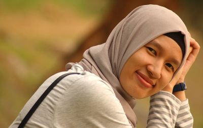 Portrait of smiling beautiful woman wearing hijab