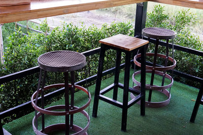 Empty chairs and table in yard