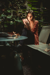 Portrait of young woman sitting at restaurant